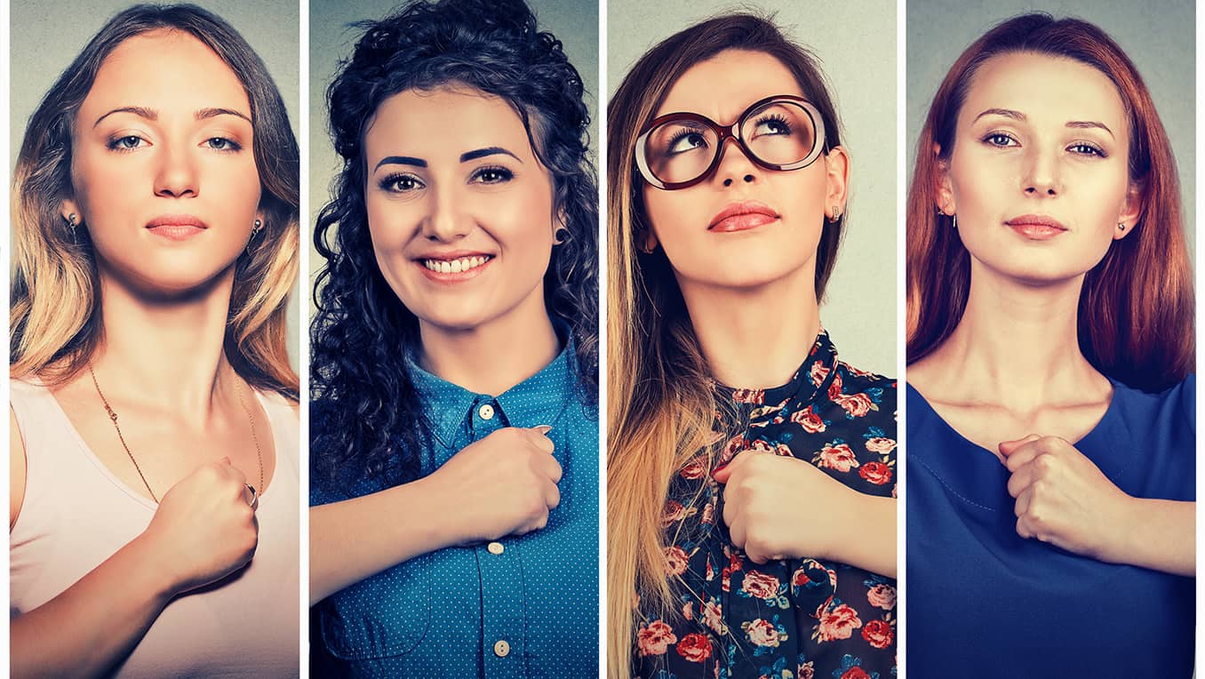 Group of confident women holding their fists across their hearts